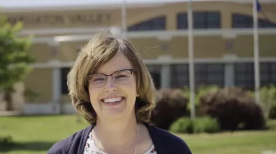 light brown haired roman wearing glasses smiling