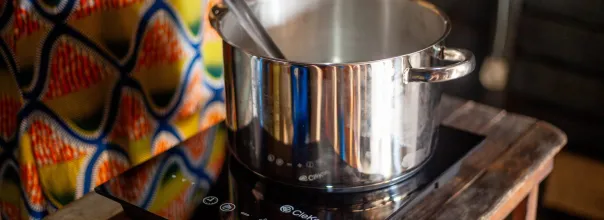 A silver pan on top of an electric stove