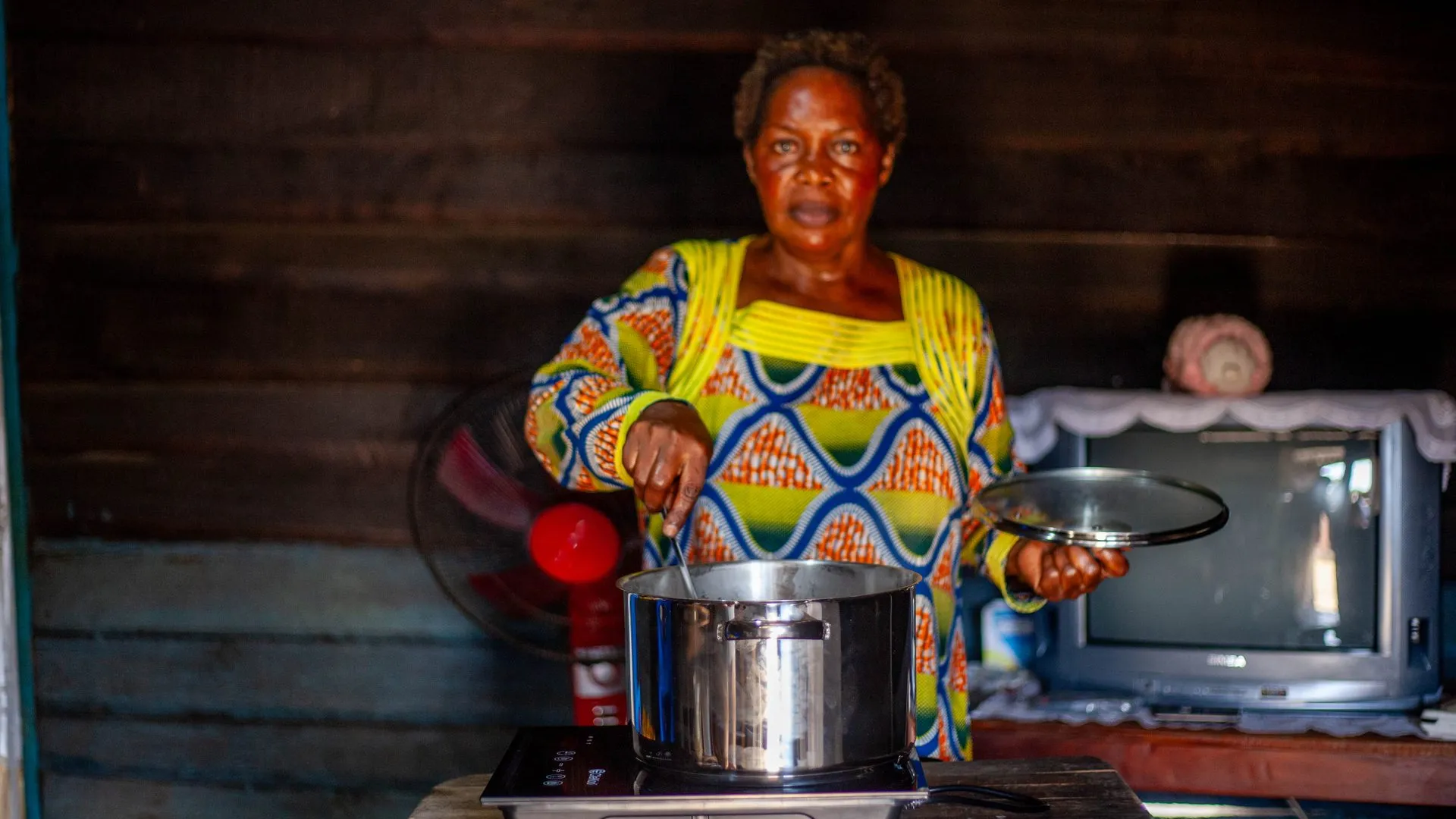 Woman stiring a pot on an smart cooktop
