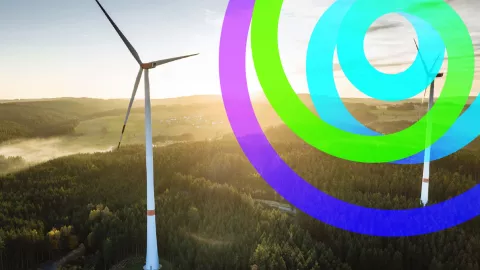 landscape of a field with two windmills and edp new logo