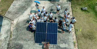 kids standing next to a solar panel